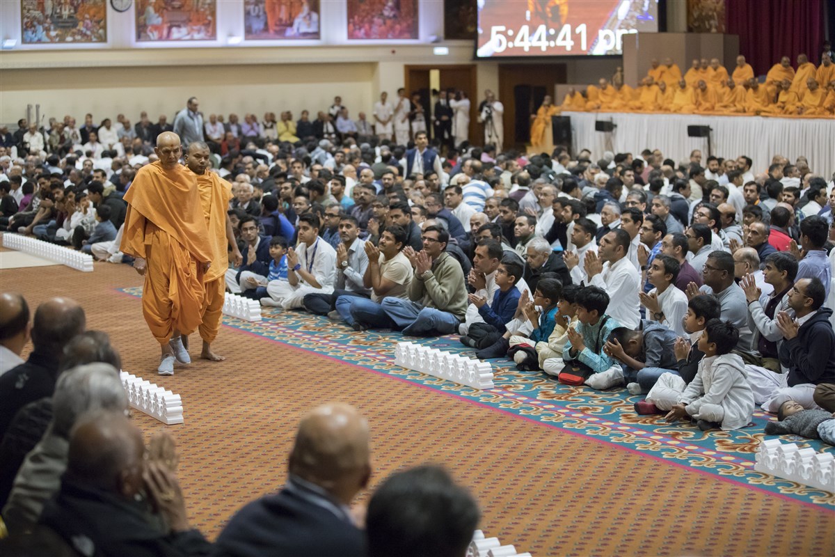 Swamishri performs his evening walk in the assembly hall