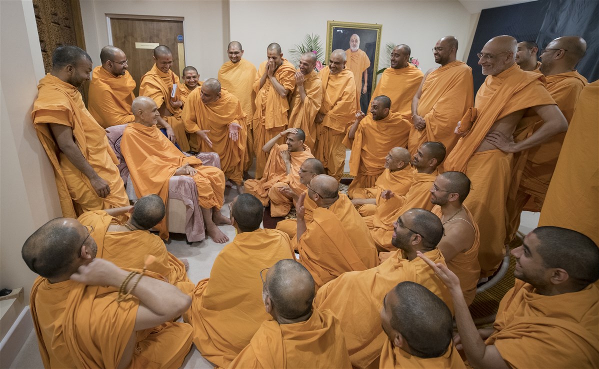 Swamishri shares a light moment with the swamis