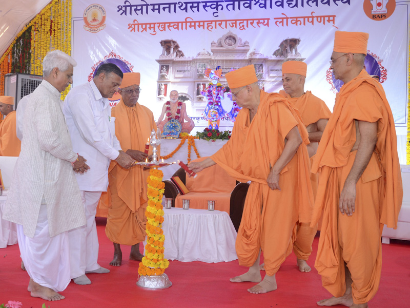 Senior sadhus and dignitaries light the inaugural lamp