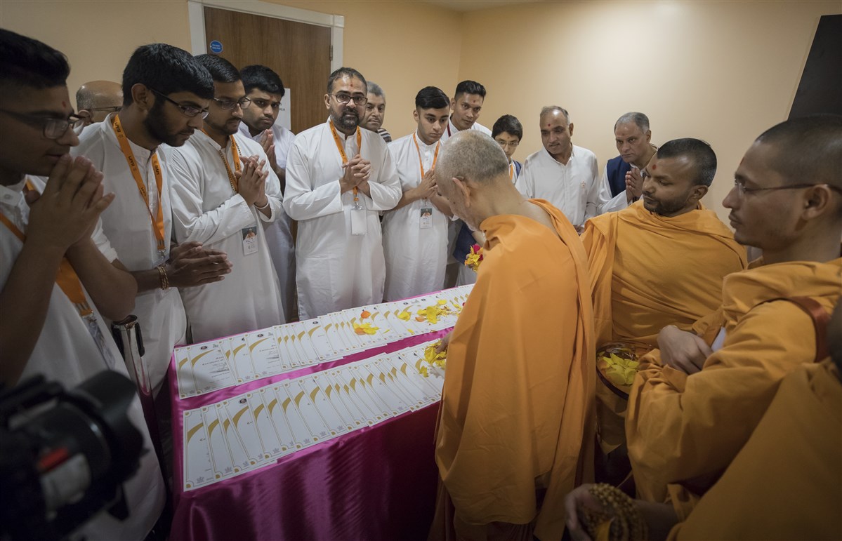 Swamishri blesses some certificates