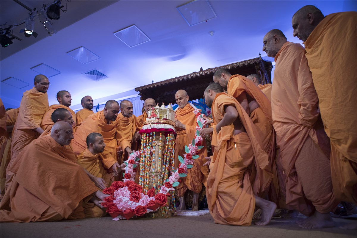 Swamis honour Shri Harikrishna Maharaj and Swamishri with a decorative garland