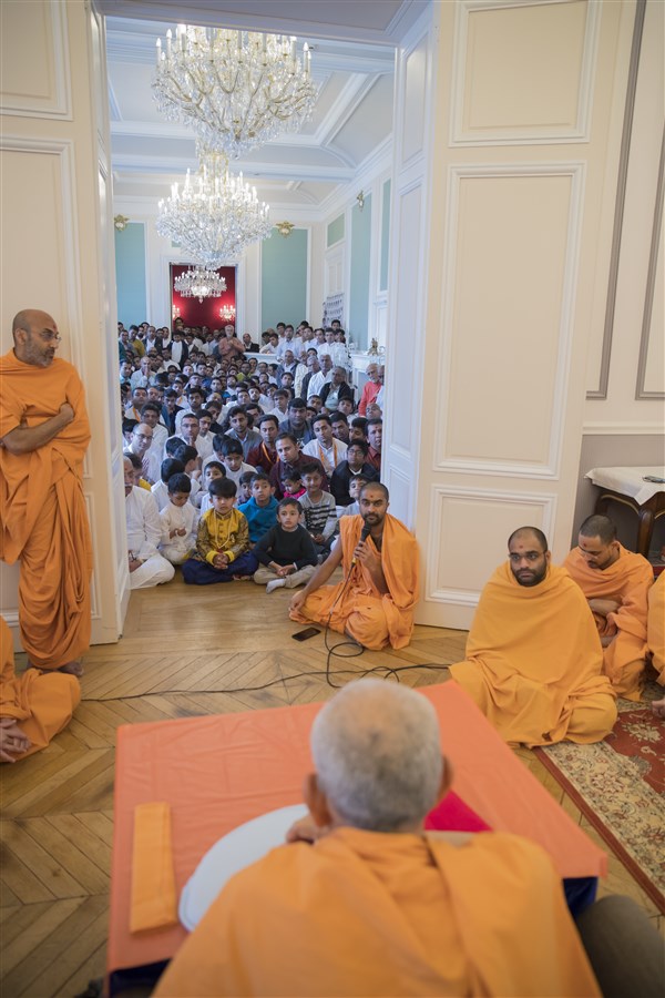 Paramsevadas Swami introduces to Swamishri volunteers from various European countries