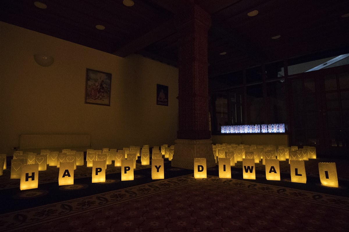 A decorative arrangement of lights greets Param Pujya Mahant Swami Maharaj...