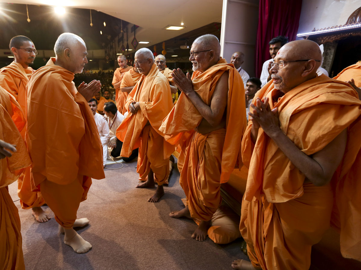 Swamishri greets Pujya Doctor Swami, Pujya Kothari Swami and Pujya Tyagvallabh Swami with 'Jai Swaminarayan' 