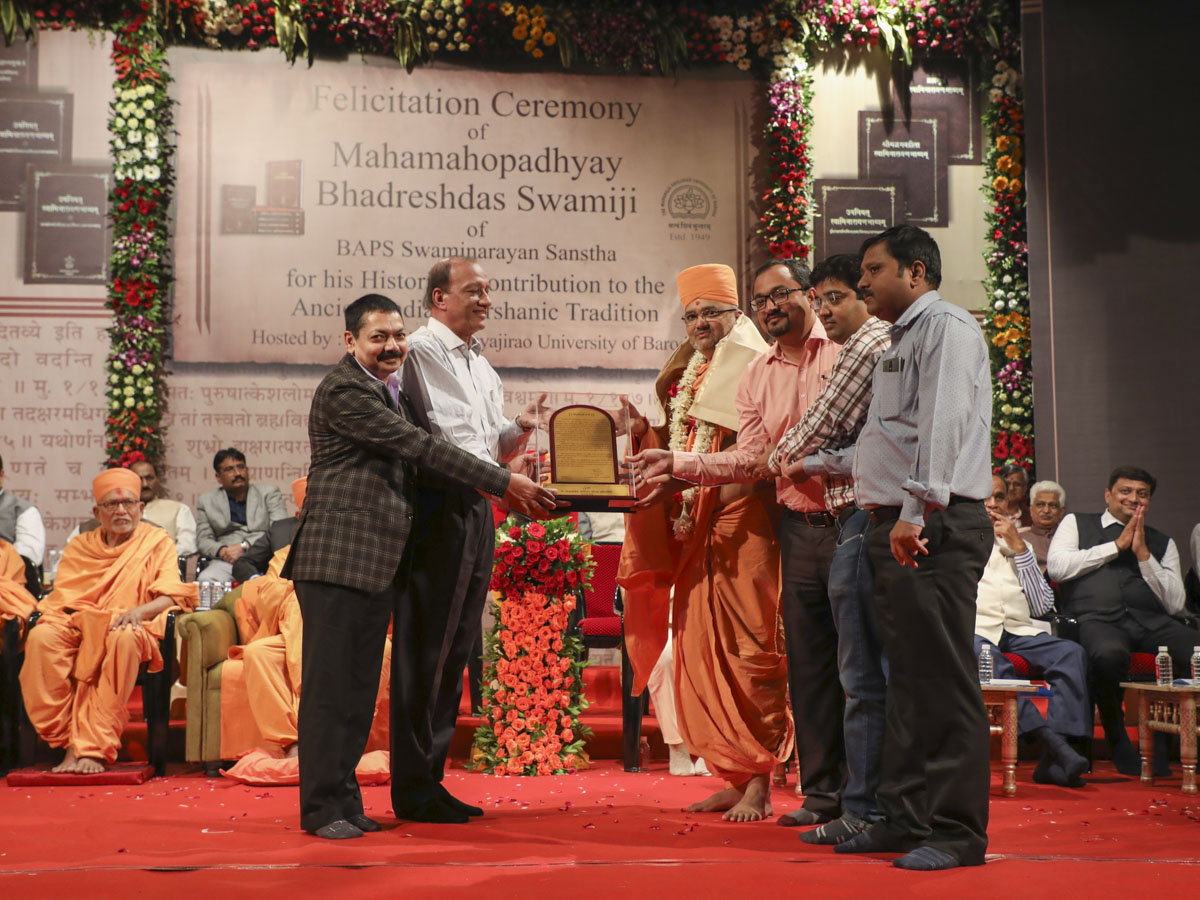 Vice Chancellor Dr. Pankaj Jani and representatives of Dr. Babasaheb Ambedkar Open University, honor Bhadresh Swami