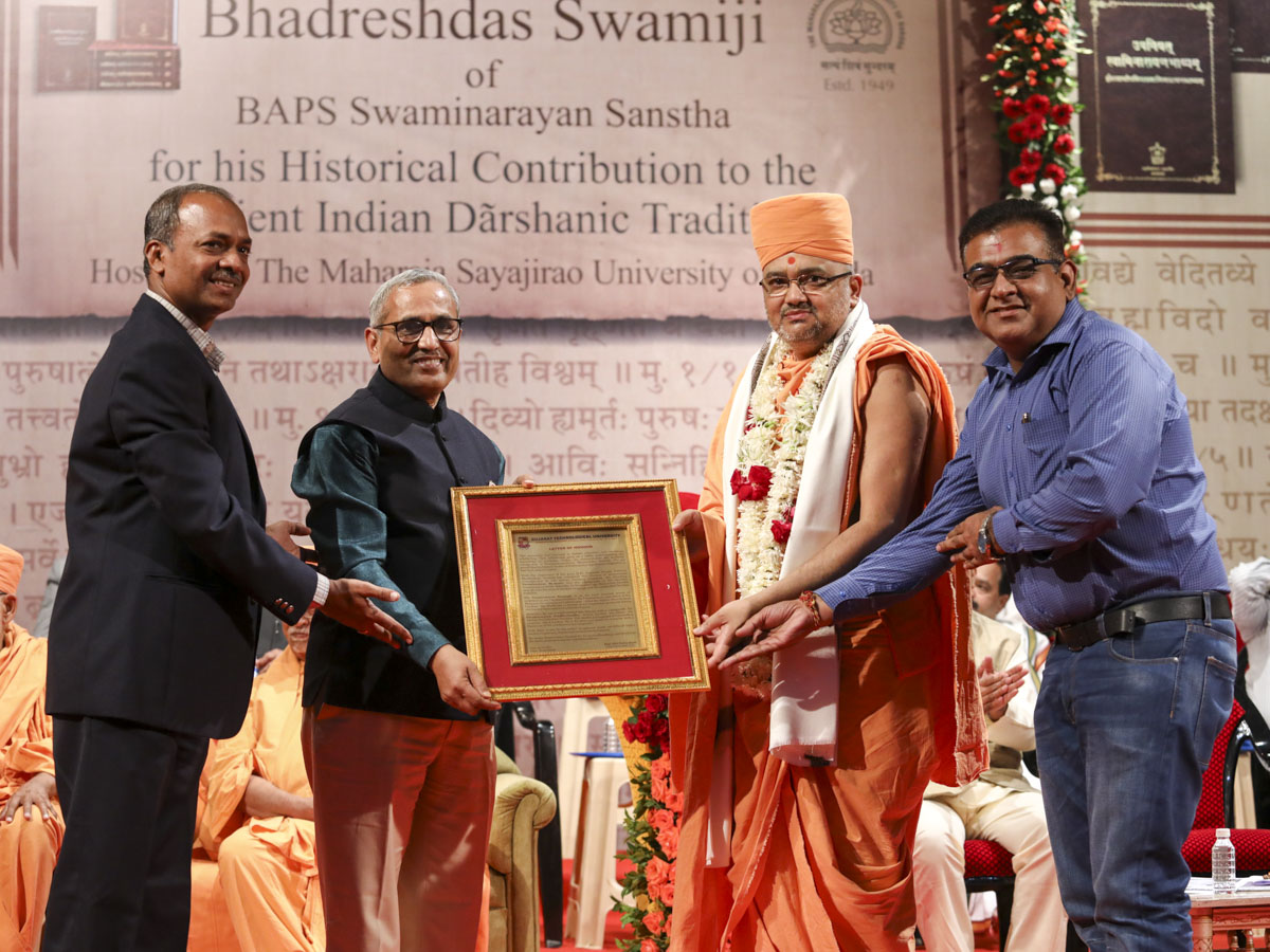 Vice Chancellor Dr. Navinbhai Sheth and representatives of Gujarat Technological University honor Bhadresh Swami