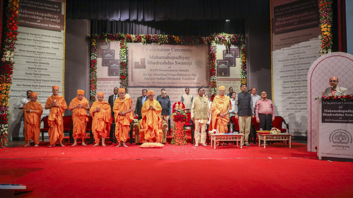 Senior sadhus, vice chancellors and university representatives stand for the national anthem