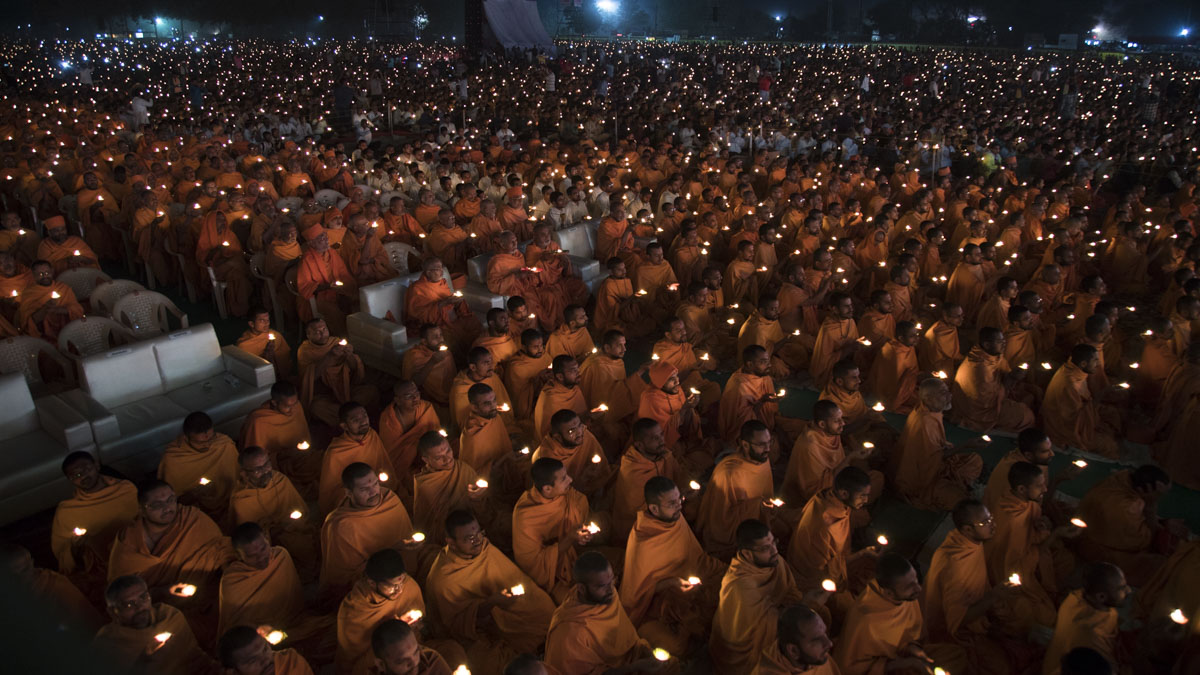 Sadhus and devotees perform arti