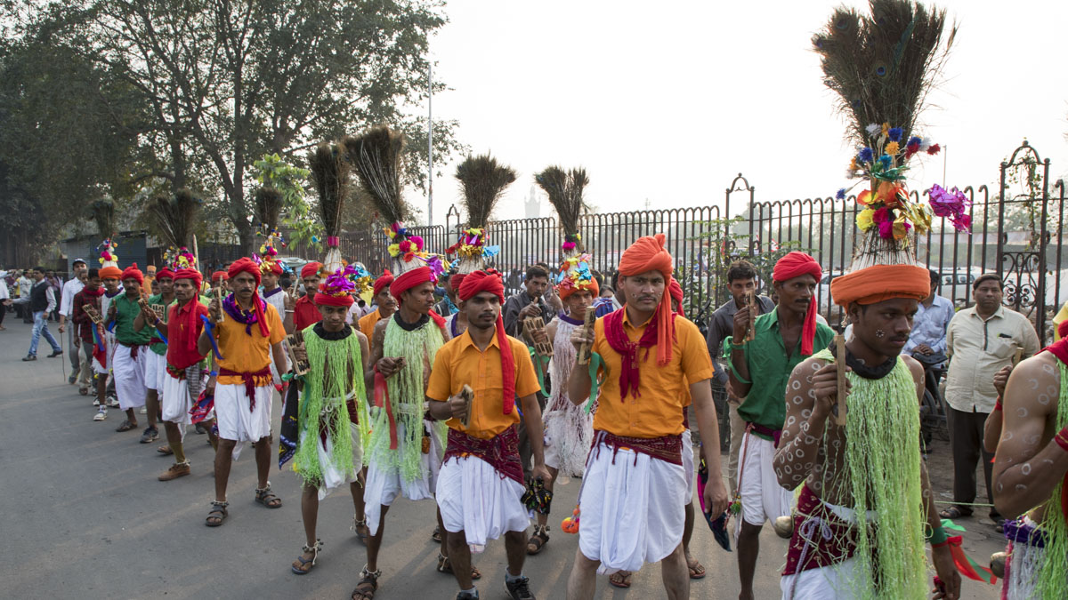 Tribal devotees from the region participate in the procession