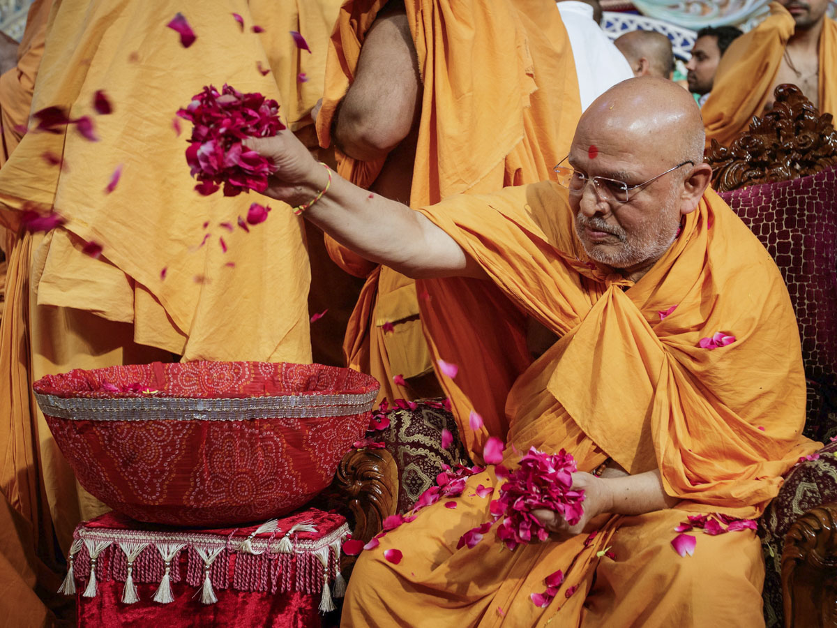 Ghanshyamcharan Swami showers sanctified flower petals on devotees