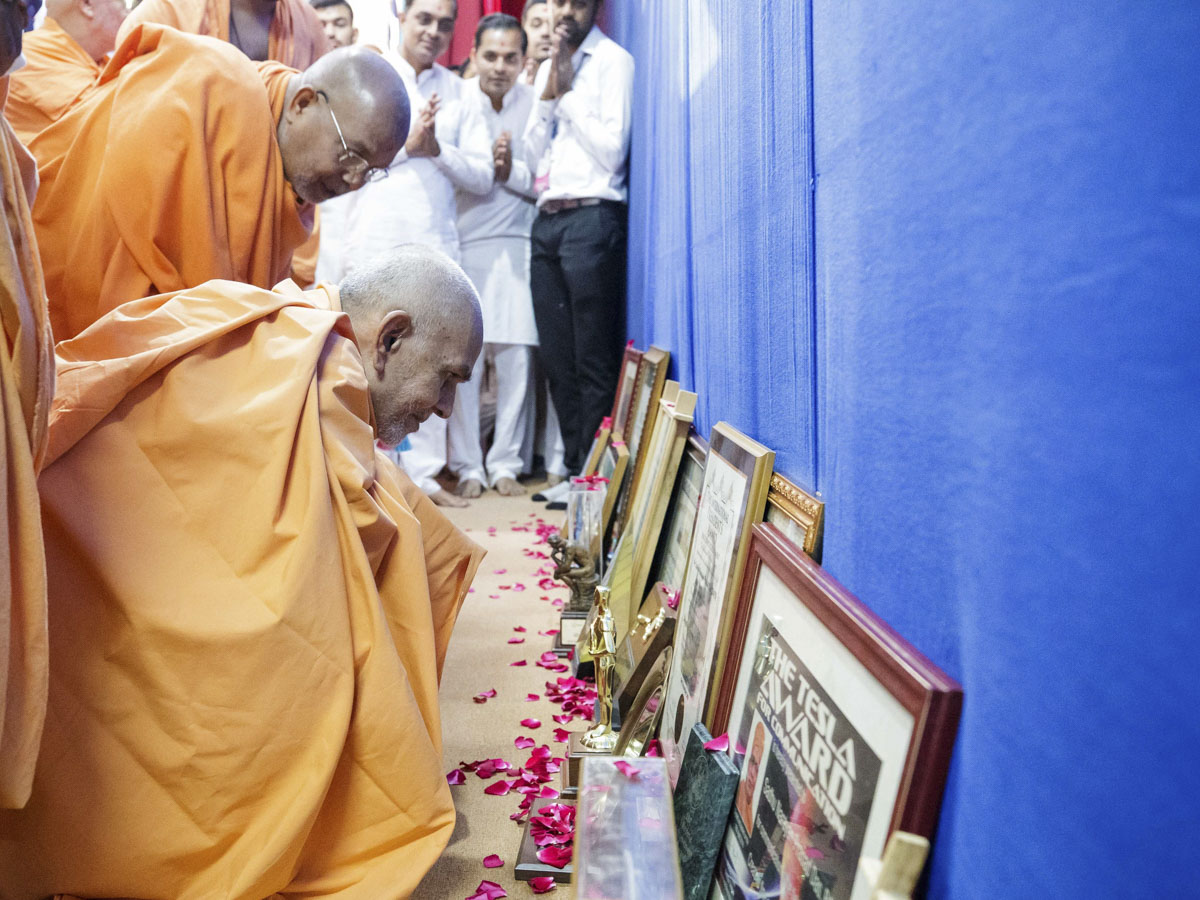 Swamishri observes awards received by Narayanprasad Swami