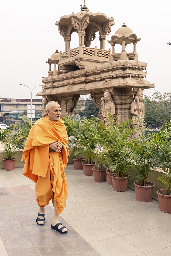 Swamishri walking in the mandir campus