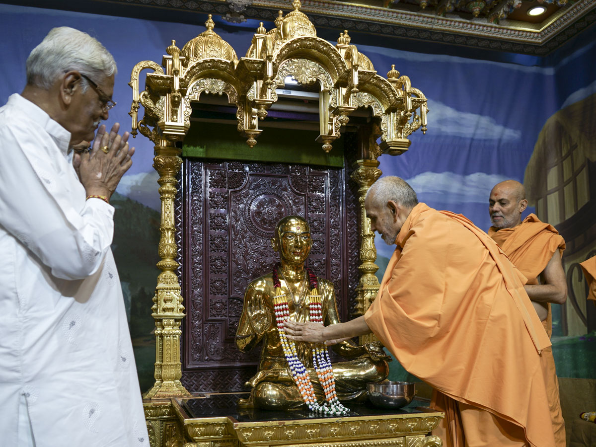 Swamishri offers a garland to Bhagwan Swaminarayan