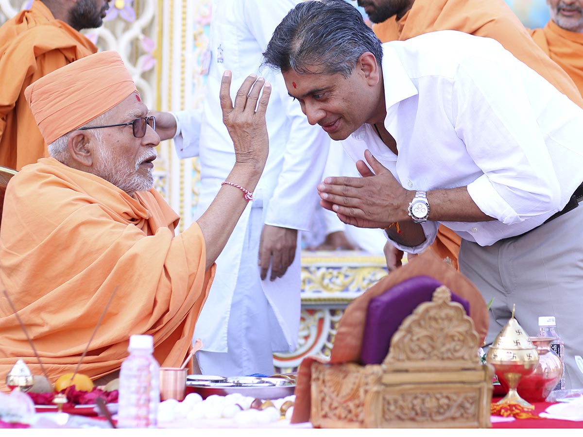 Pujya Kothari Swami applies chandlo to a devotee