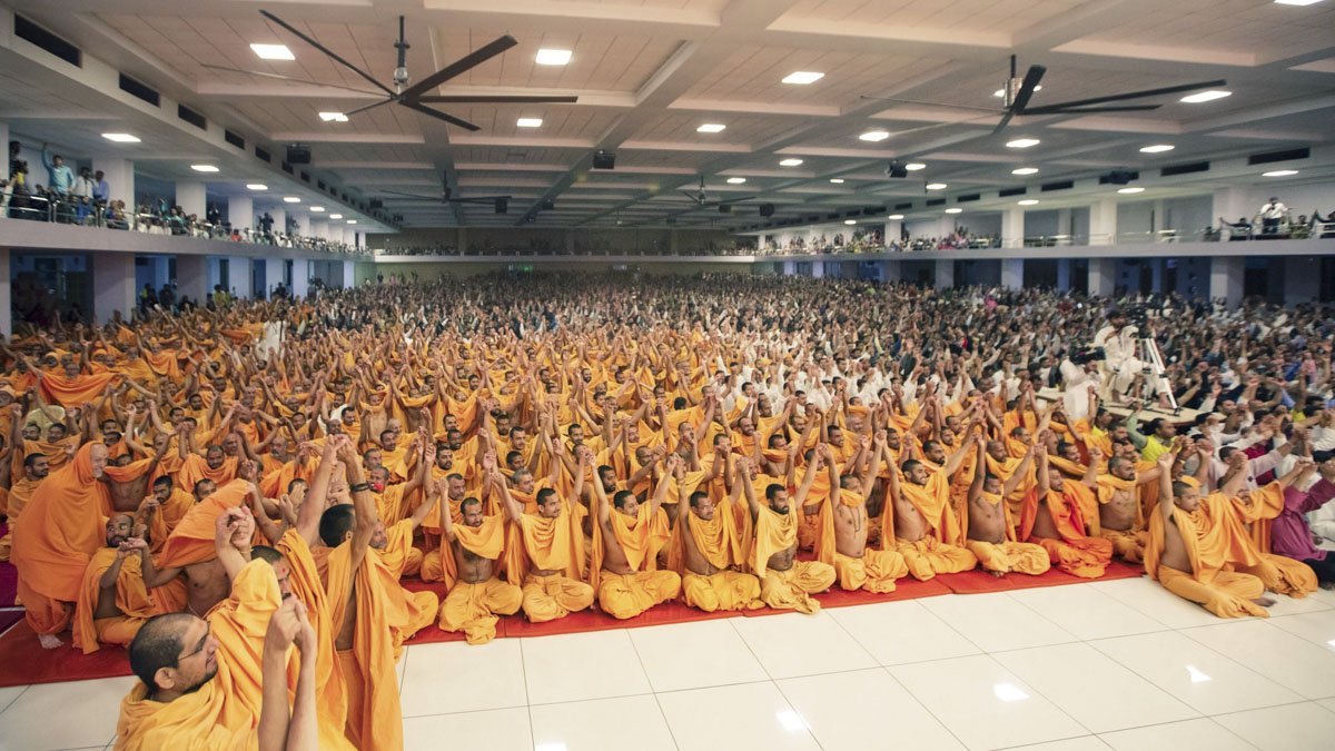 Swamis and devotees join hands in a gesture of unity