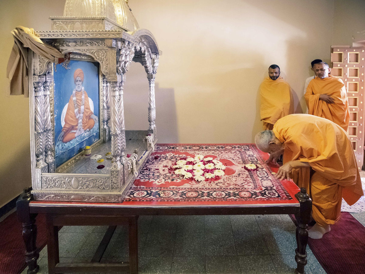 Swamishri engrossed in darshan of Shastriji Maharaj's room