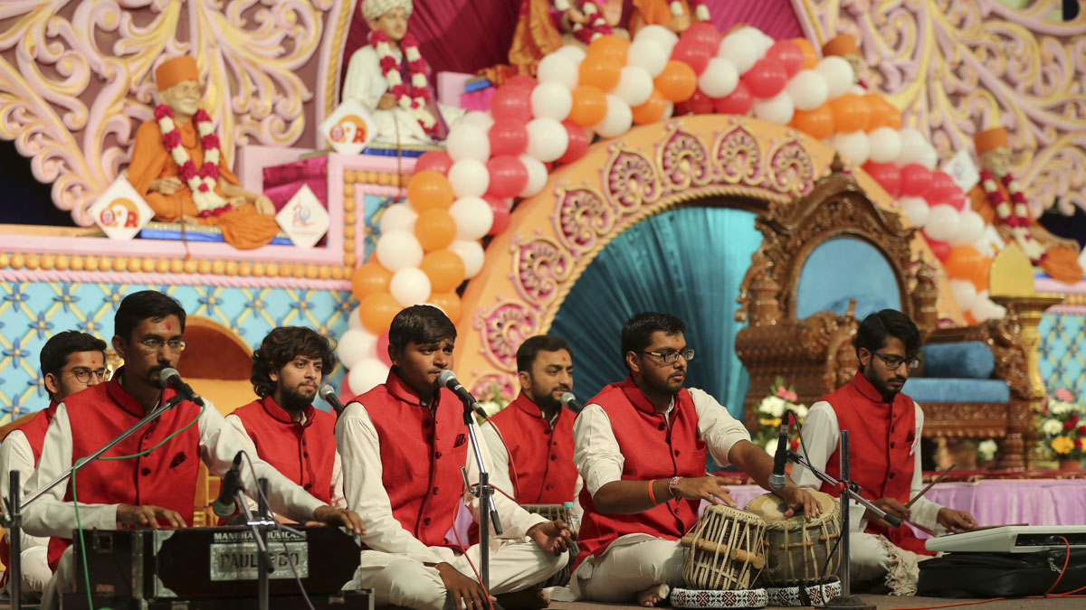 Youths sing kirtans in the evening assembly presented by the devotees of Rajkot