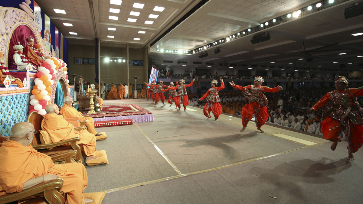 Youths perform a traditional dance in the evening satsang assembly