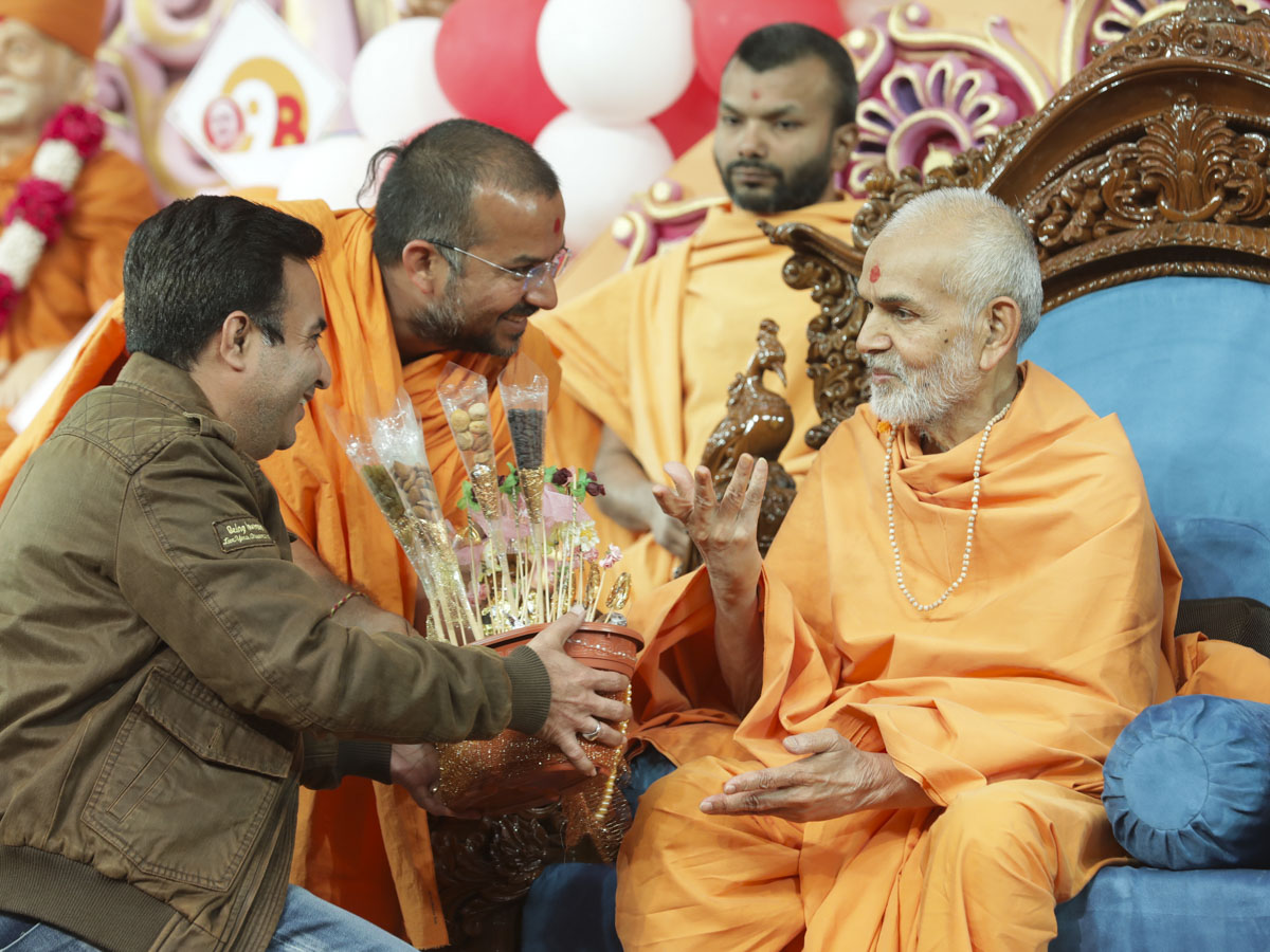 Swamishri interacts with a devotee