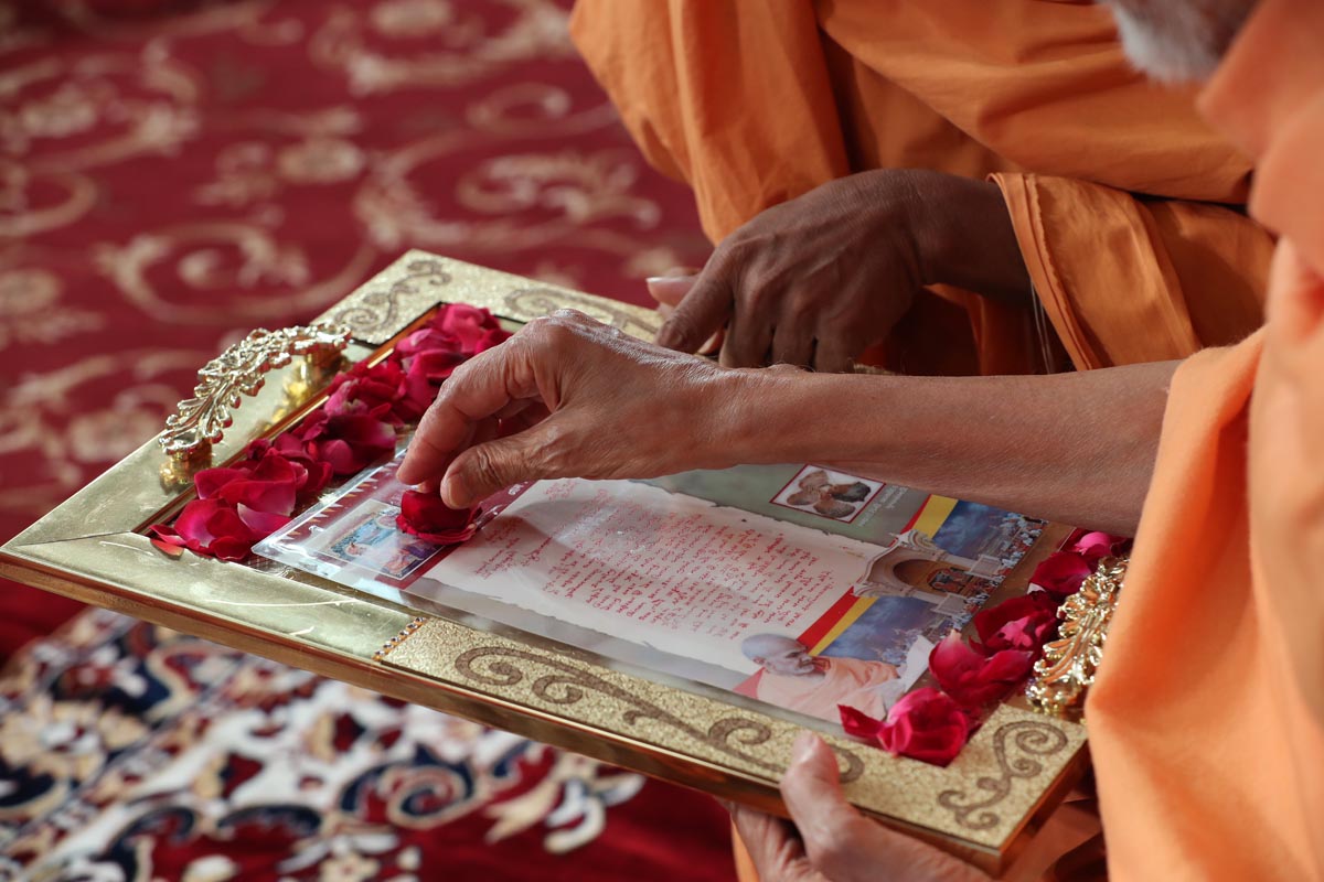 Swamishri sanctifies a memento for the volunteers who served in the 150th Anniversary Celebrations of the Akshar Deri