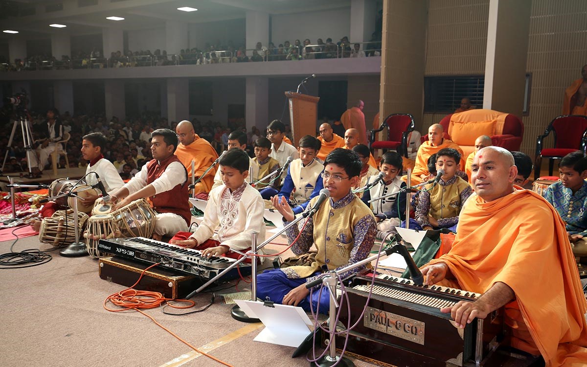 Students of Swaminarayan Vidyamandir, Gondal, sing kirtans in Swamishri's puja
