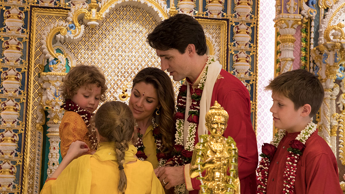 Ella-Grace Margaret ties a nadachhadi to her brother, Hadrien