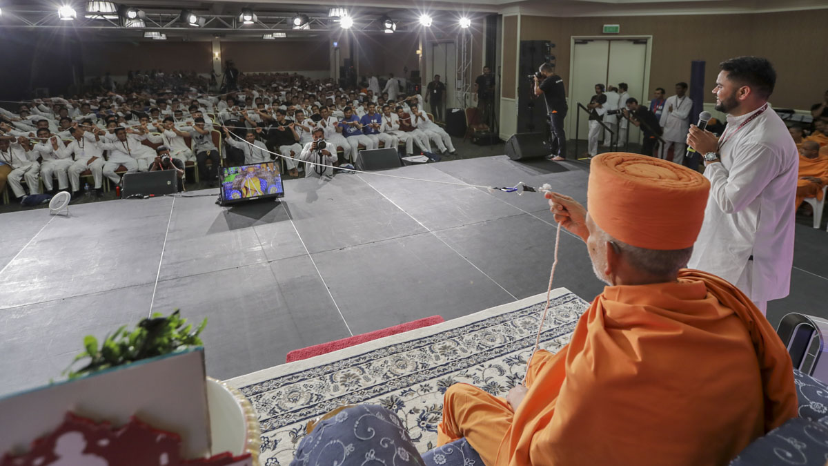 Swamishri participates in an activity with the youths