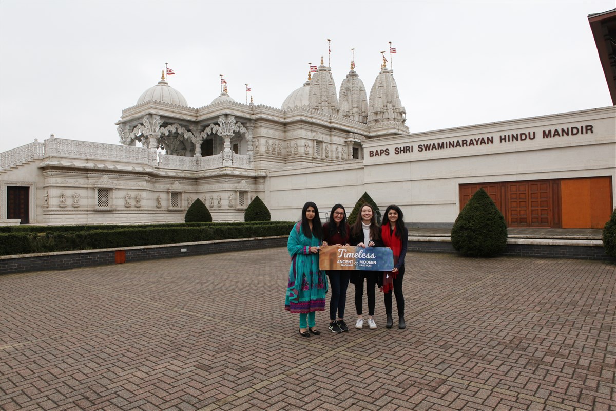 Friends take photo mementoes upon arrival at the Mandir