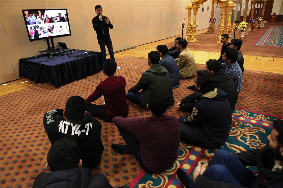 A young volunteer presents a workshop on seva