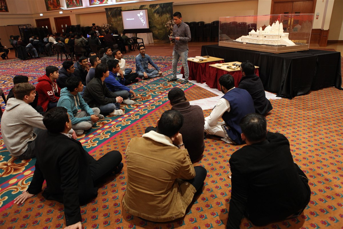 A youth explains the history of the Mandir