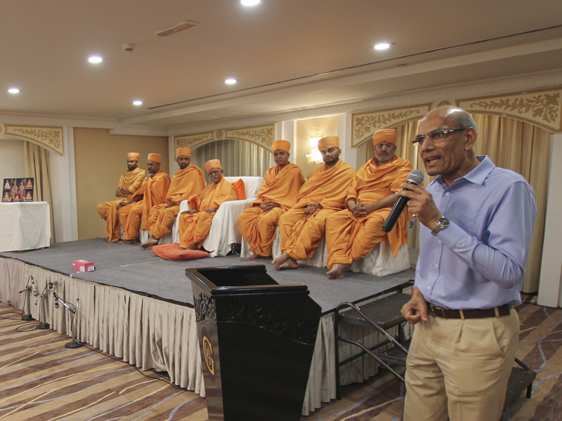 Pujya Doctor Swami and sadhus on stage during the assembly