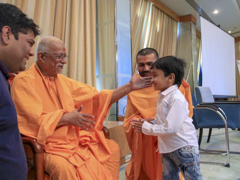 Pujya Doctor Swami blesses a child