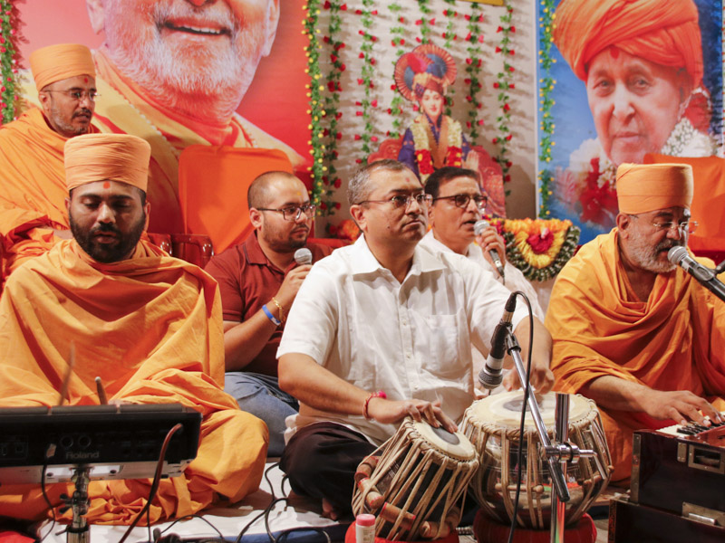 Sadhus sing kirtans during the assembly