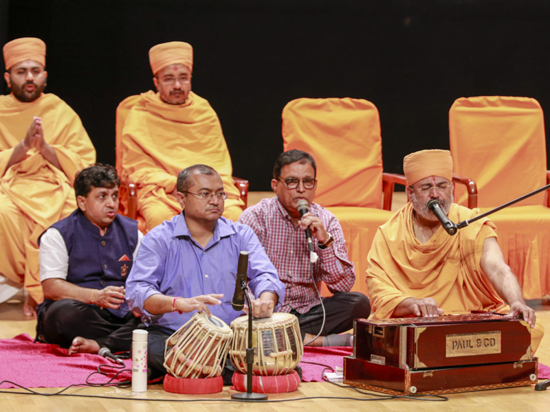 Sadhus and devotees sing kirtans during the assembly