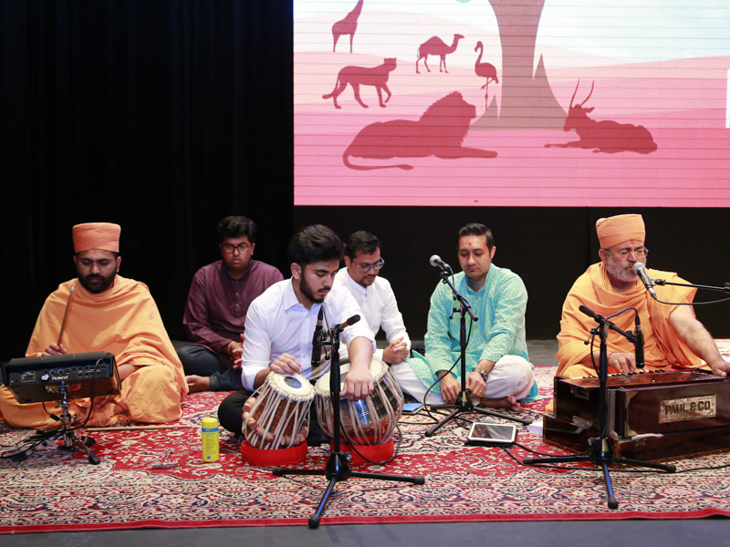 Sadhus sing kirtans in the assembly