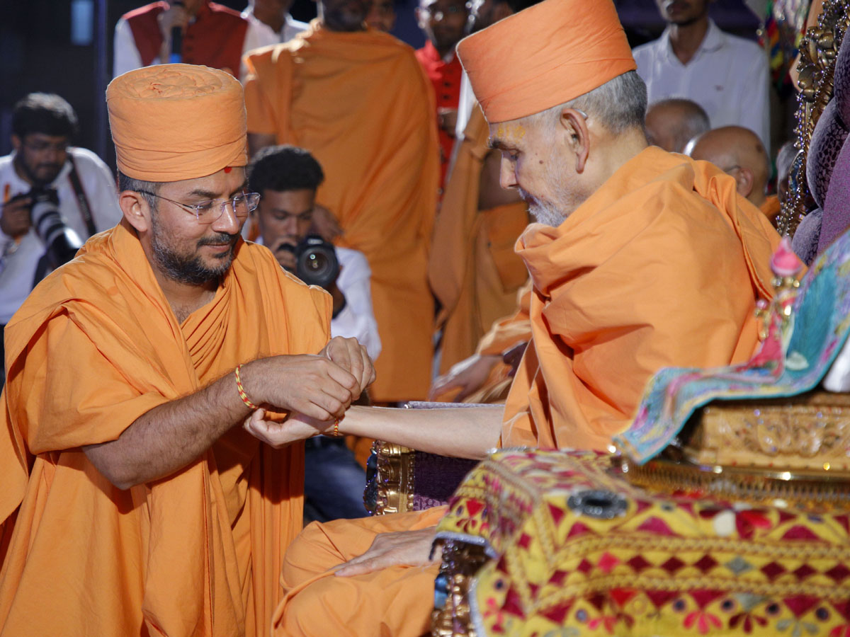 Apurvamuni Swami ties a nadachhadi to Swamishri
