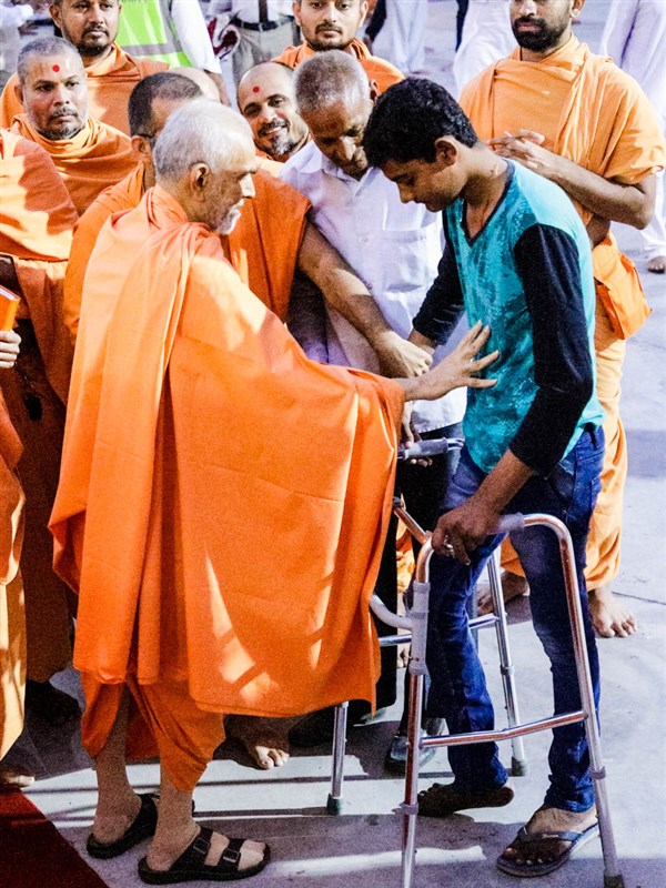 Swamishri blesses an ailing youth