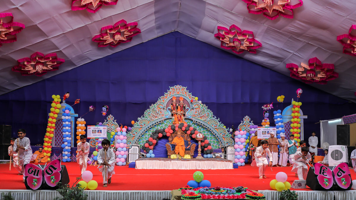 Children perform before Swamishri in the evening Bal Din assembly
