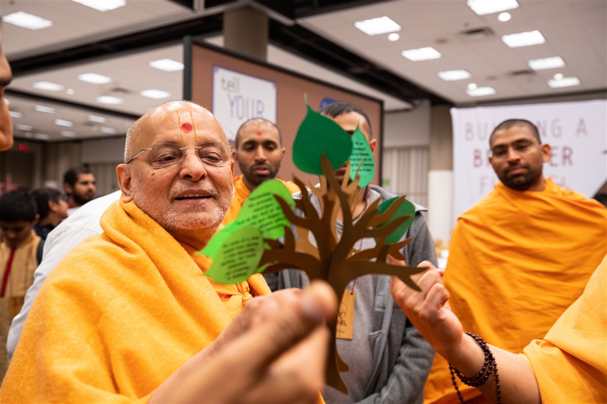 Pujya Ishwarcharandas Swami views the thematic decorations around the convention site