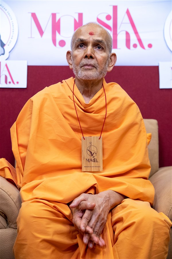 Param Pujya Mahant Swami Maharaj watches the morning session of the BAPS North American Youth Convention  live from Sarangpur, Gujarat, India 
