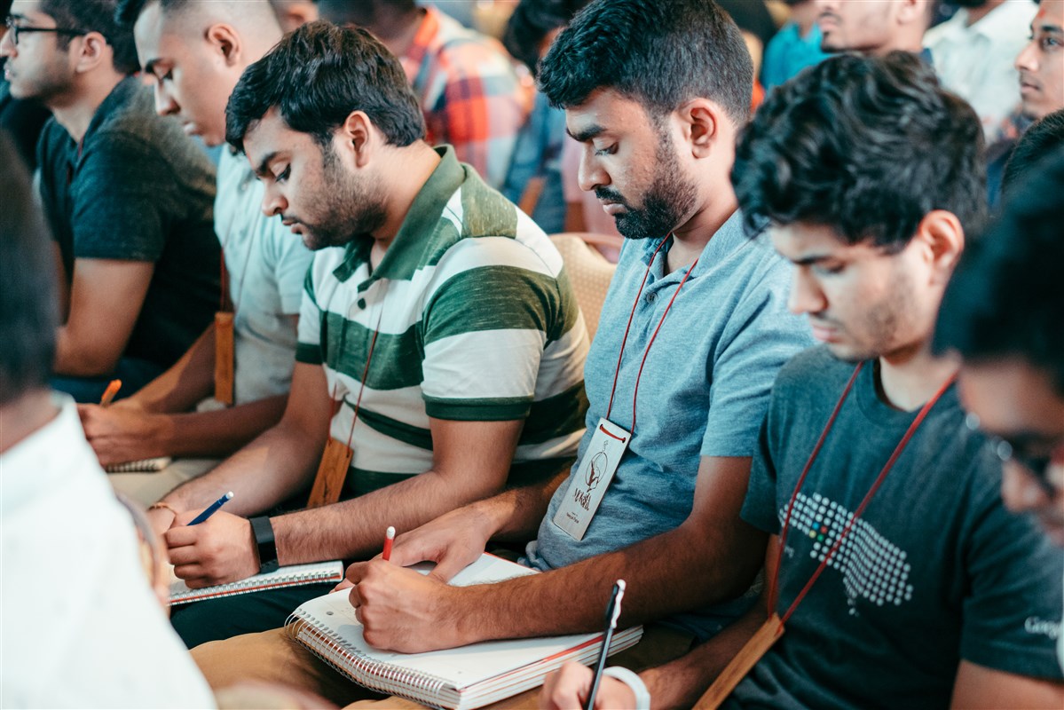 Delegates take notes in their journals