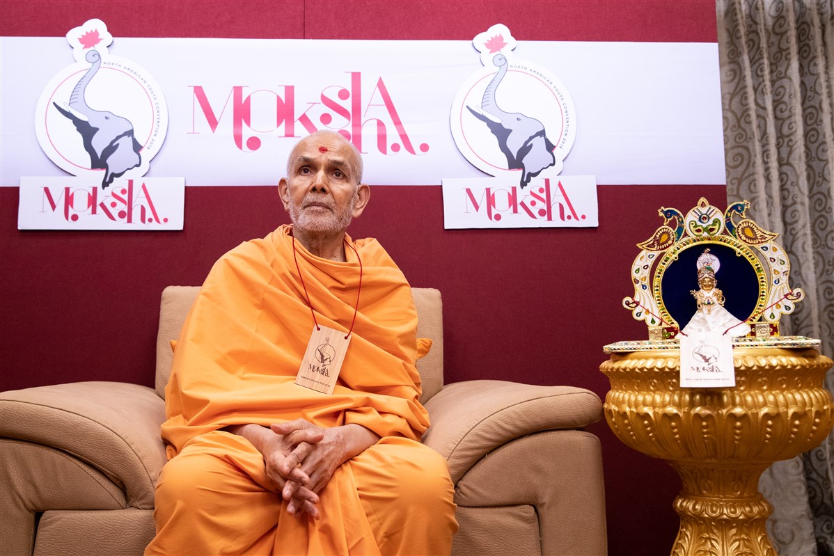 Param Pujya Mahant Swami Maharaj watches the morning session of the BAPS North American Youth Convention live from Sarangpur, Gujarat, India