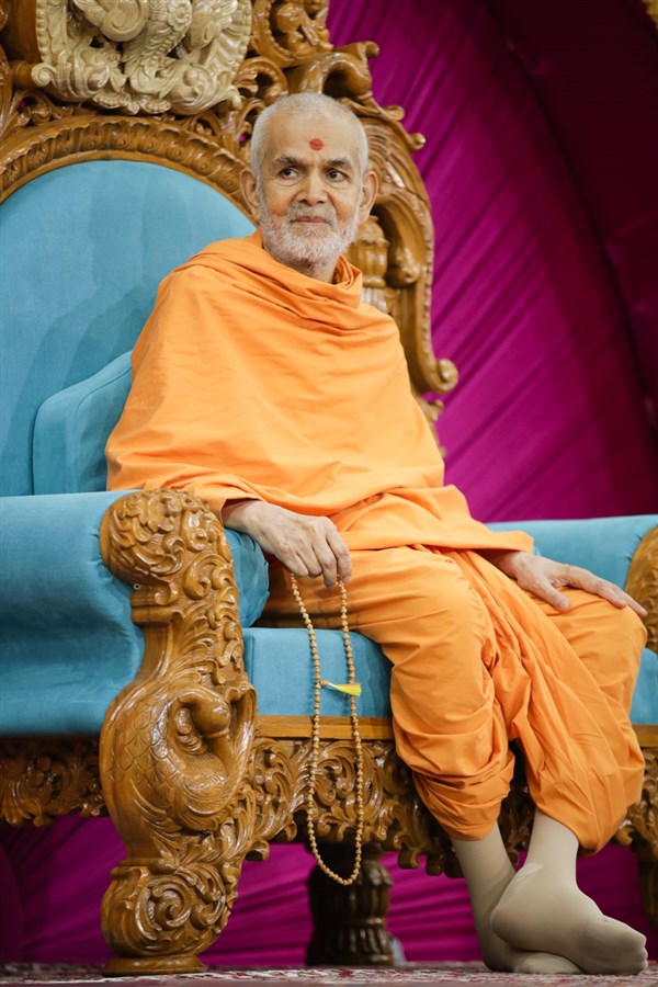 Swamishri smiles while watching the skit