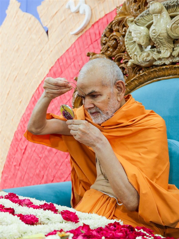 Swamishri applies tilak in his morning puja