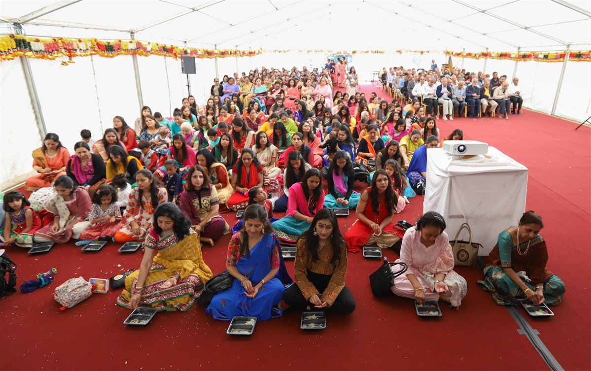 Devotees participate in the mandir inauguration mahapuja