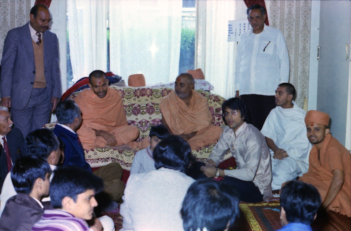 Pramukh Swami Maharaj and Mahant Swami at the home of a devotee, East London, 1977