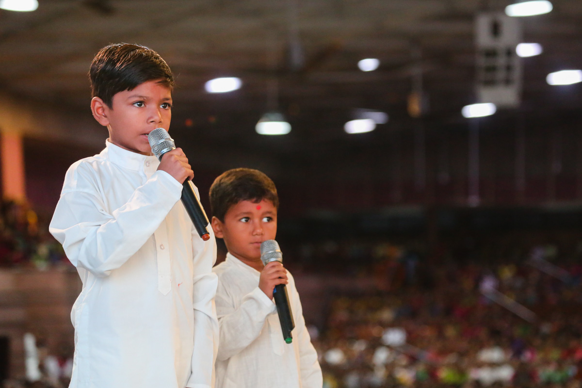 Children present mukhpath  before Swamishri 