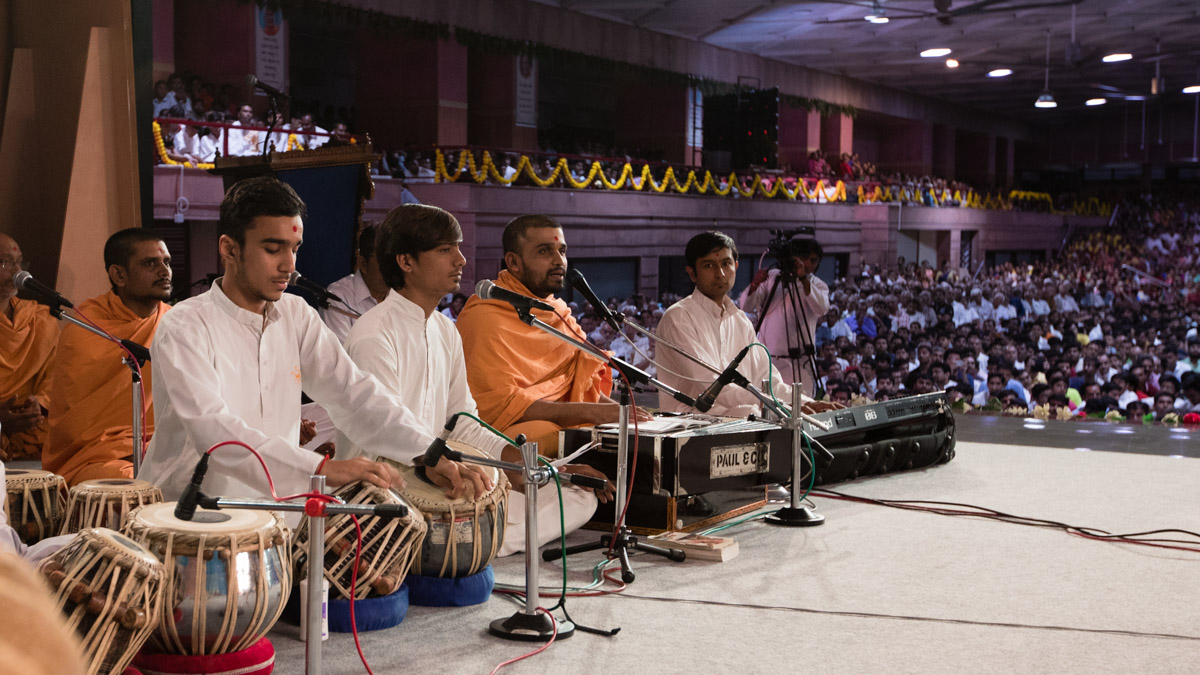Youths sing kirtans in Swamishri's puja