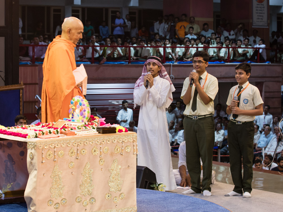 Students of BAPS Swaminarayan Vidyamandir, Raisan, present mukhpath before Swamishri in various languages