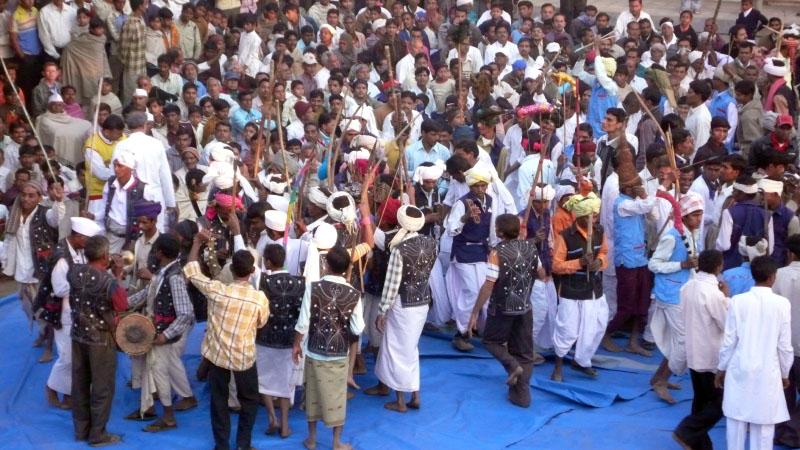 Tribal devotees rejoice by dancing and singing kirtans